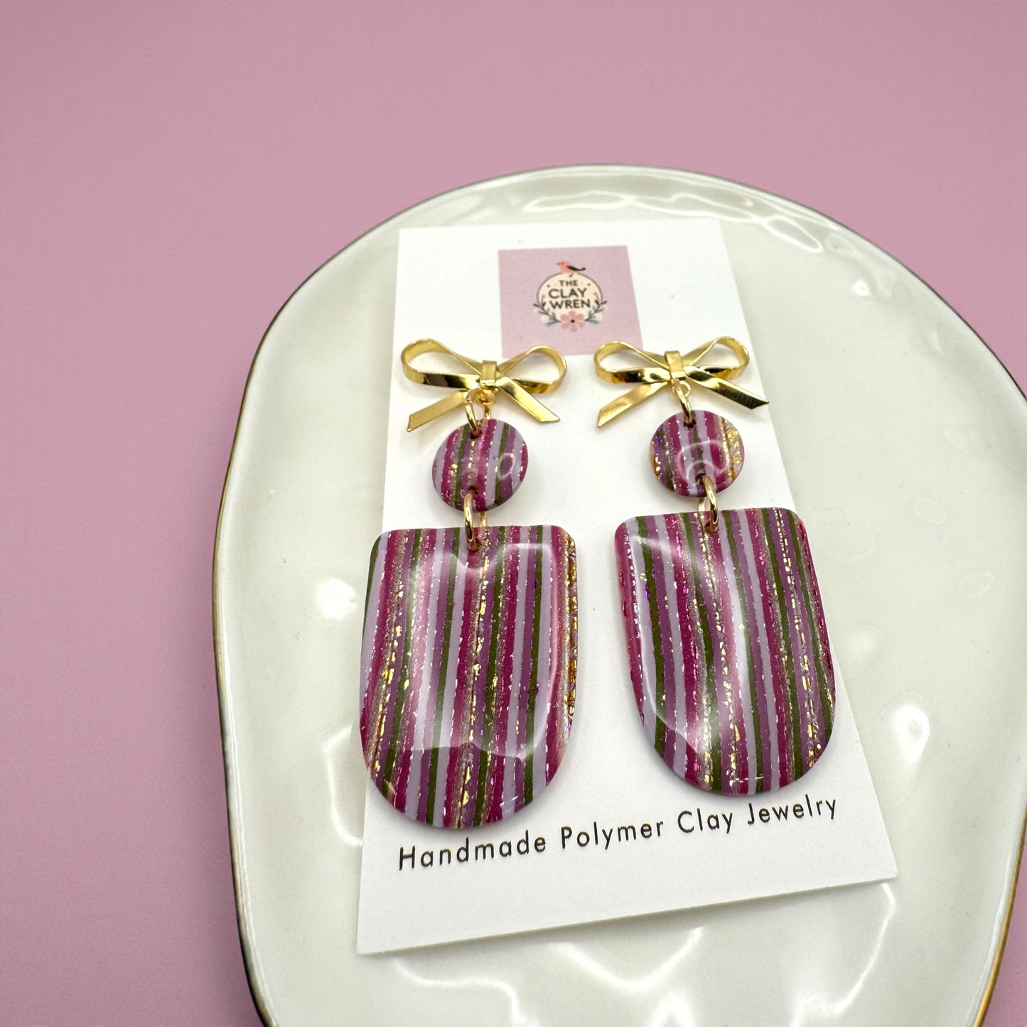 Pinkmas vertical striped arches with gold bow stud