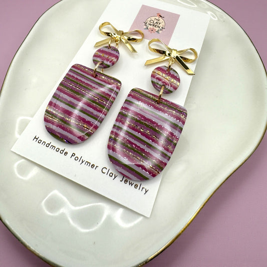 Pinkmas horizontal striped arches with gold bow stud