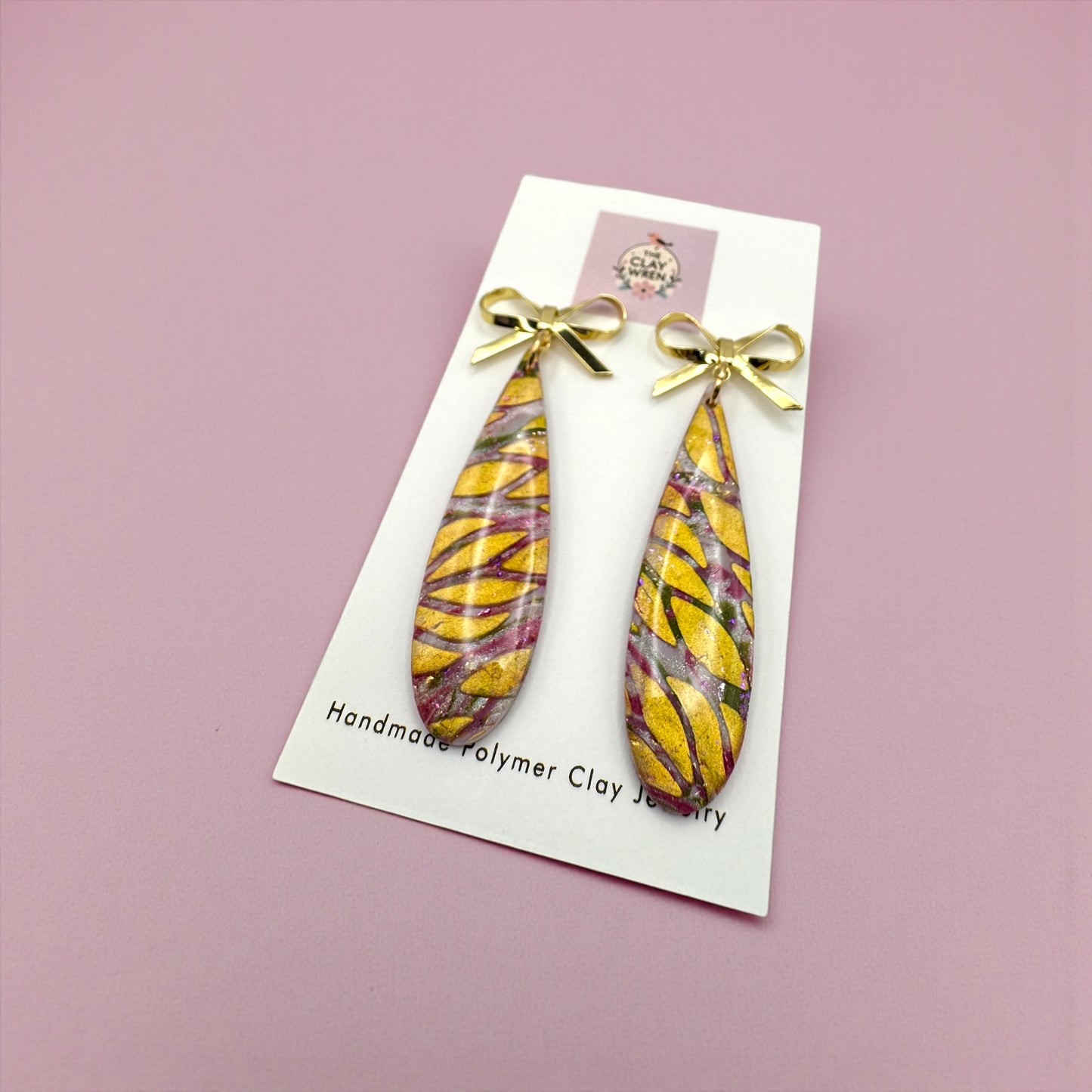 Pinkmas dangles with gold bow stud