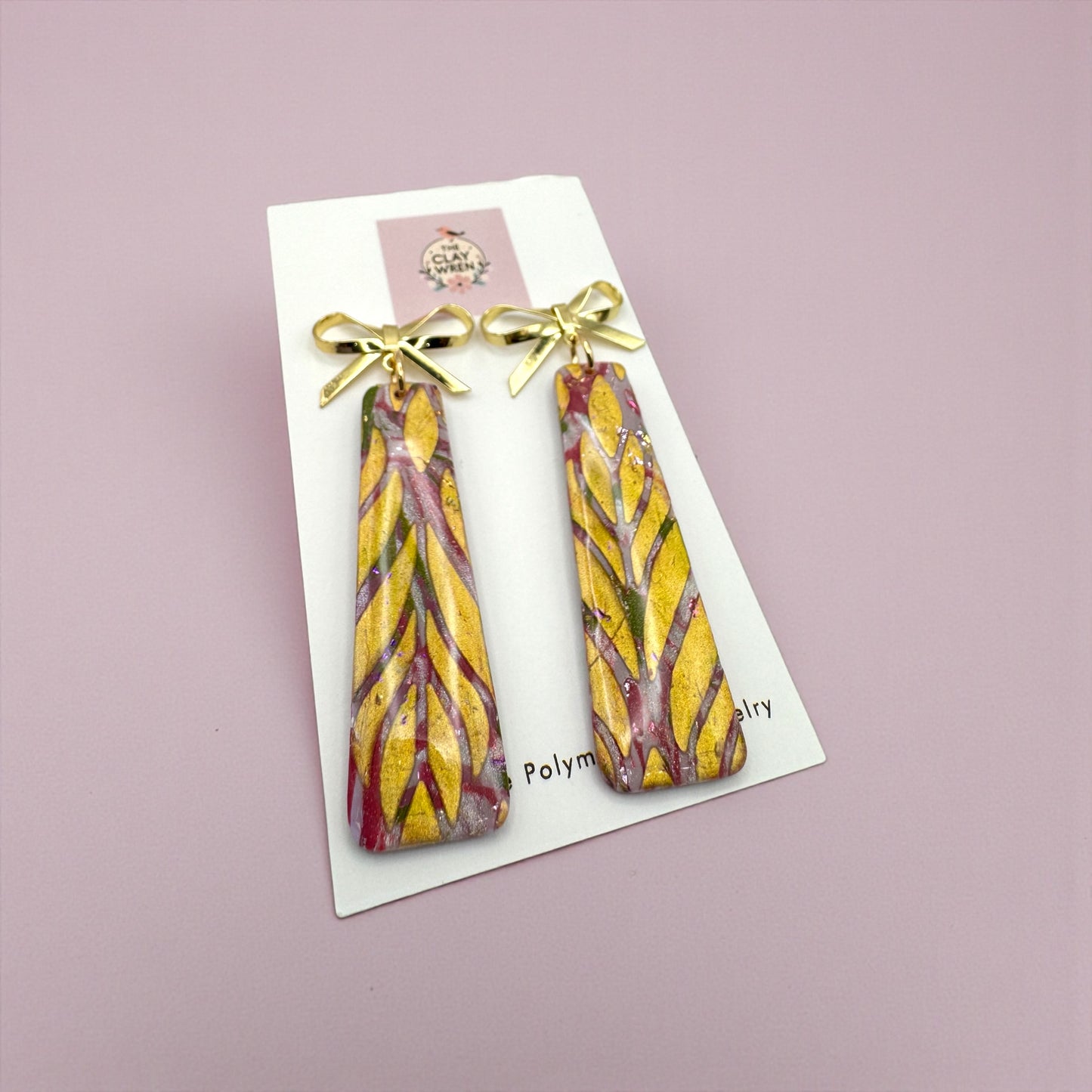 Pinkmas dangles with gold bow stud