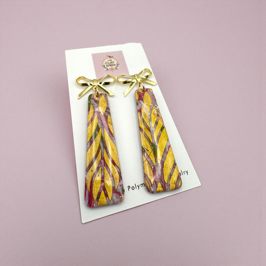 Pinkmas dangles with gold bow stud