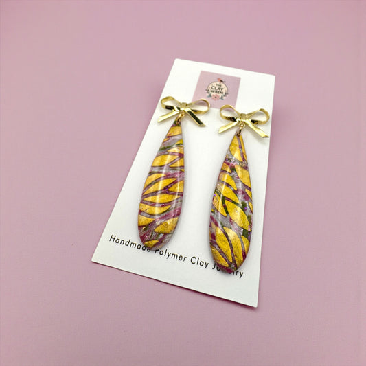Pinkmas long tear drop dangles with gold bow stud